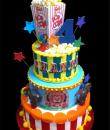 Circus Birthday cake, Yellow, Blue and white Buttercream iced,  3 round tiers decorated with stripes, stars, elephants, lions, dots, gumballs, gumpaste number, Print Letters and Popcorn box.  Everything on this cake is EDIBLE even the popcorn box. (Serves  48-135 party slices)