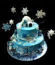 Let it Snow 1st Birthday cake,  Blue buttercream iced, 2 round tiers topped with an igloo and decorated with pearls, snowflakes, polar bears and penguins, all bundled up and ready for winter play. Everything on this cake is EDIBLE.   (Serves 28-55 party slices)