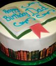 Book Lovers Birthday Cake,  White buttercream iced,  round decorated with an edible wrap and topped with an open book. Everything on this cake is EDIBLE. (Serves 8-80 party slices)