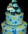 Stars and Circles Cupcake 1st Birthday cake,  Blue buttercream iced, 2 round tiers topped with cupcakes, decorated with circles, stars and dots. Everything on this cake is EDIBLE.  (Serves 28-55 party slices)