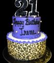 Purple Leopard 21st Birthday Cake. Purple and white buttercream iced, round, 2 tiers, decorated with an edible leopard wrap and pearls. Everything on this cake is edible. (Serves 28-55 party slices,) 