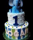 Elephant 1st Birthday Cake,  Blue and white buttercream iced, 2 round tiers decorated with dots, edible fondant stripes, and a sweet blue baby elephant to top it off. Everything on this cake is EDIBLE.  (Serves 28-55 party slices)