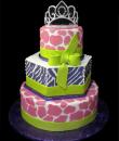 Animal Print Birthday cake, White Buttercream iced, 3 tiers round and hexagon decorated with fondant giraffe spots, Zebra print edible wrap, fondant ribbon and bow, everything on this cake is EDIBLE except the plastic crown was provided by client. (Serves  48-135 party slices)