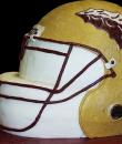 Football Helmet Birthday cake,  This white and gold buttercream iced,  shaped cake can be decorated with the color and team of your choice.  Everything on this cake is EDIBLE.  