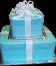Gift Wrapped Birthday cake,  Blue buttercream iced,   2 square tiers decorated with fondant ribbon and bow. Everything on this cake is EDIBLE.  (Serves 47-75 party slices)