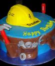 Tool Belt Birthday Cake. Blue buttercream iced, round decorated with a hard hat, edible tool belt and plastic tools. Everything on this cake is edible. (Plastic tools provided by client.) (Serves 8-80 party slices.) 