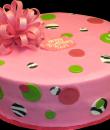 Dots and Bow Birthday Cake. Pink buttercream iced, round decorated with circles, dots, zebra print and a bow. Everything on this cake is edible. (Serves 8-80 party slices.) 