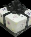 Custom Gift Wrapped Birthday Cake. White buttercream iced, square decorated with hearts, spirals, swirls, dots and flowers, all wrapped with black ribbon and bow. Everything on this cake is edible. (Serves 12-90 party slices.) 