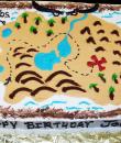 Treasure Map Birthday Cake. White buttercream iced sheet caked decorated with a treasure map, treasure chests, pirates, swords. Everything on this cake is edible. (Serves 24-98 party slices.) 